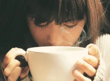 Woman smelling coffee